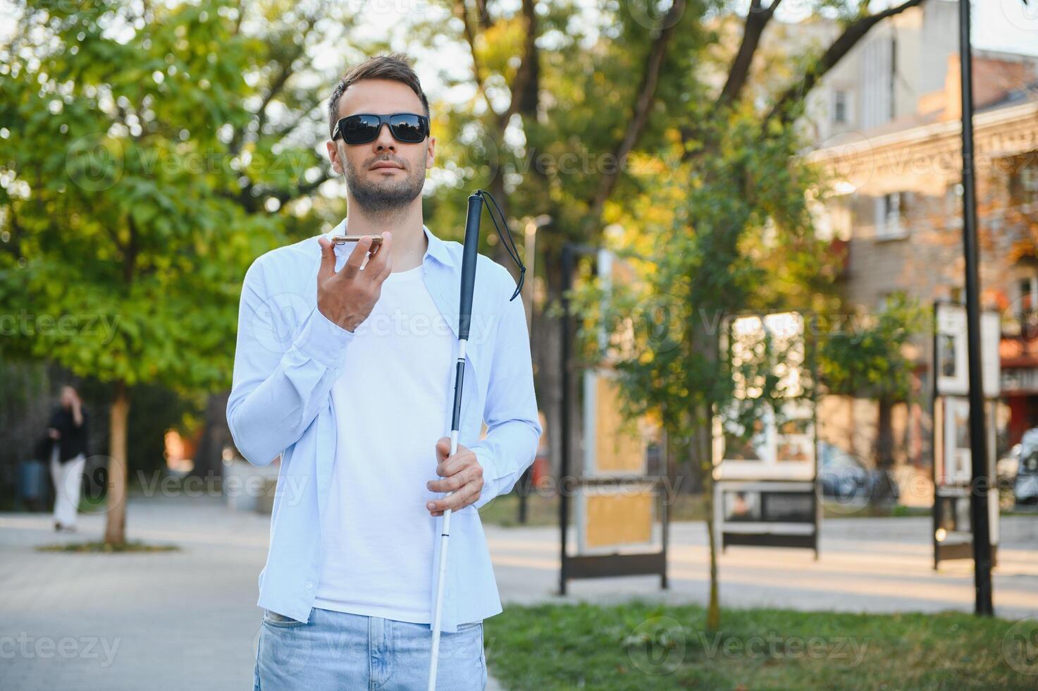 Blind man. Visually impaired man with walking stick, photo