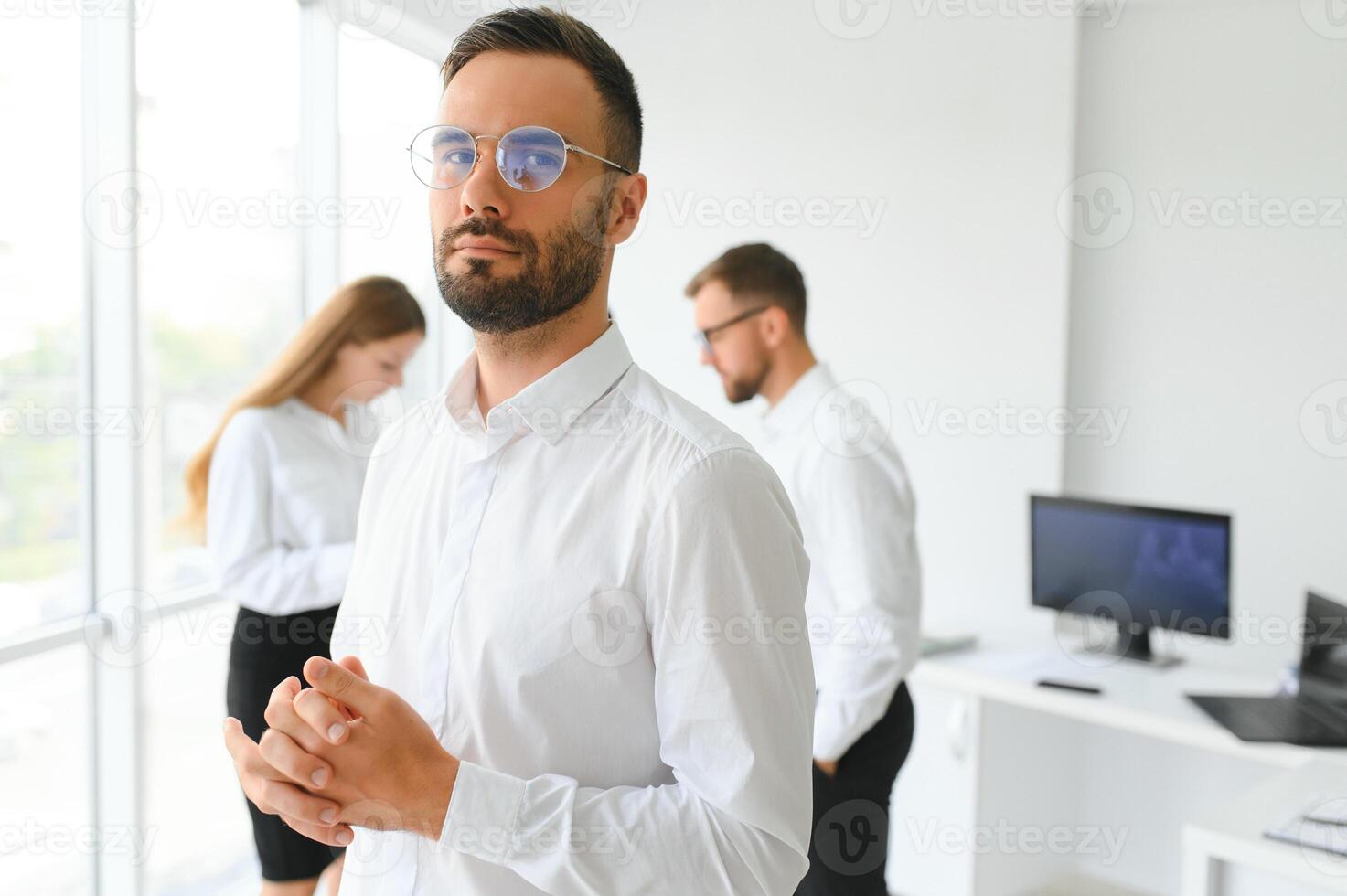 Business people stand on the background of the office corridor photo