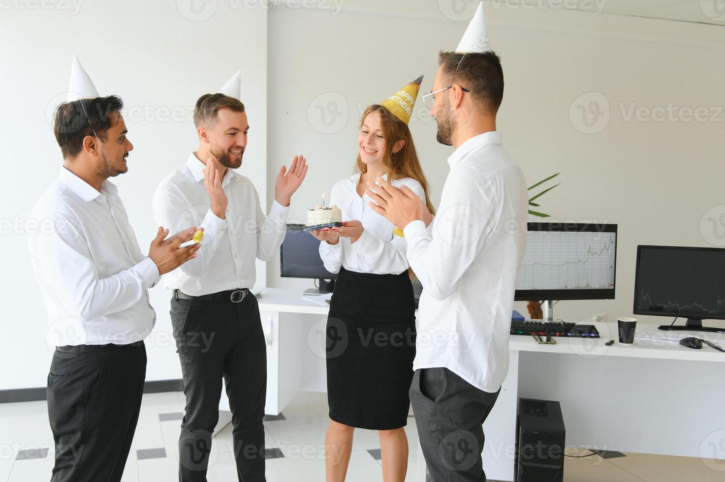 Business team celebrating a birthday of collegue in the modern office. photo