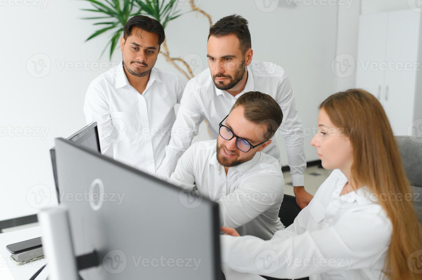 Happy businesspeople laughing while collaborating on a new project in an office. Group of diverse businesspeople working together in a modern workspace photo