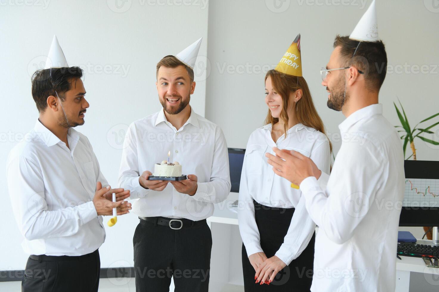 Business team celebrating a birthday of collegue in the modern office. photo
