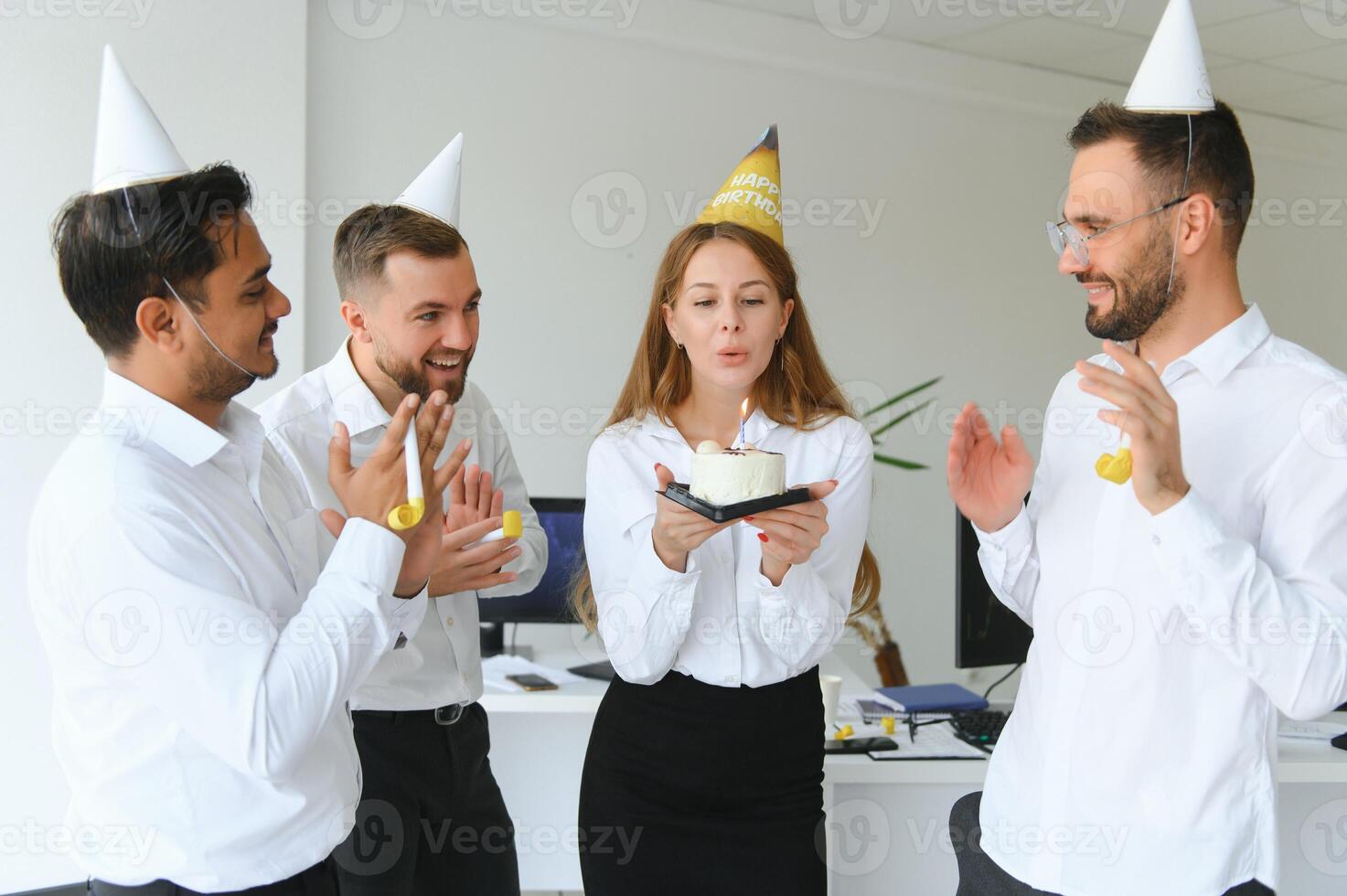 Business team celebrating a birthday of collegue in the modern office. photo