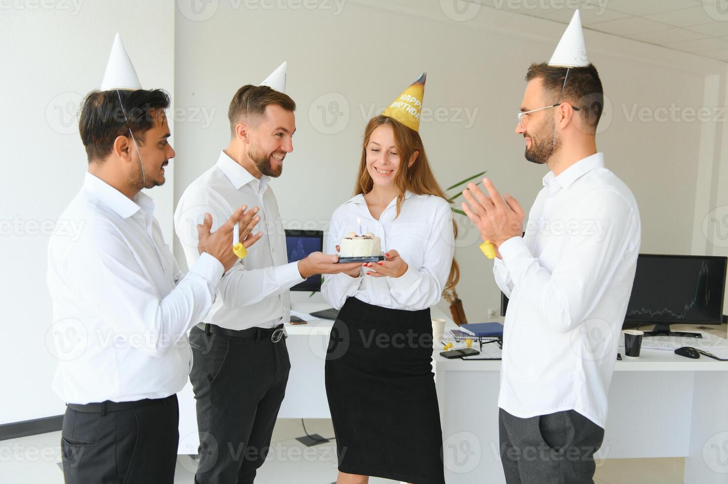 business team celebrating a birthday in the office. photo