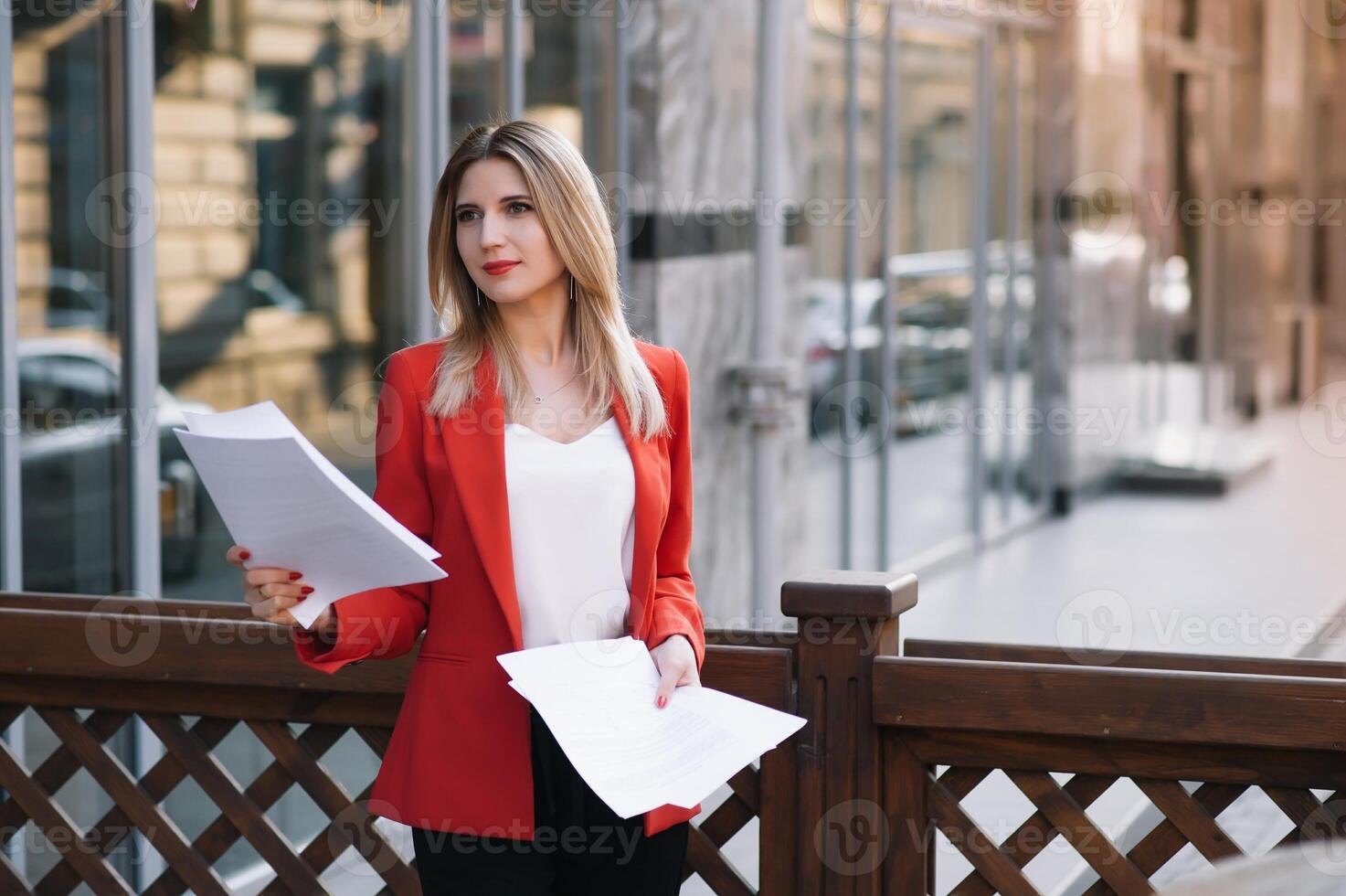 Portrait of business women in feeling of concentrate stress and see stand and hold the paper file sheet in the outdoor pedestrian walk way with the city space of exterior modern facade building photo