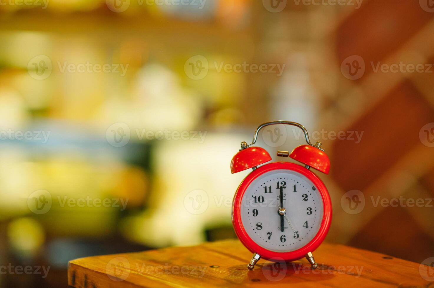 an alarm clock at 6 am on a blurry background photo