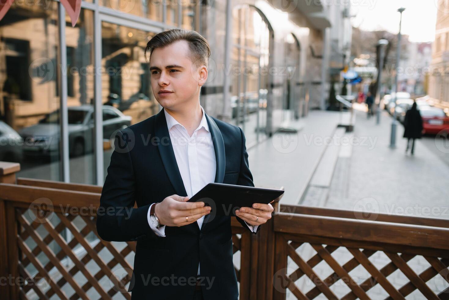 Young business man with tablet near of modern building. photo