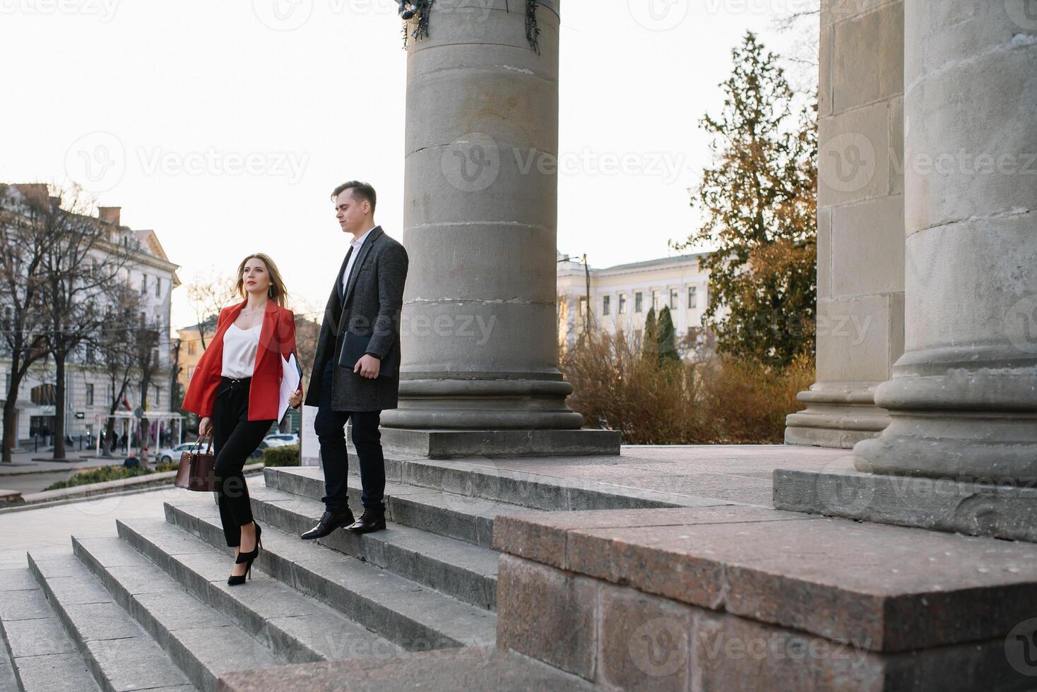 Young business people walking together along the street photo