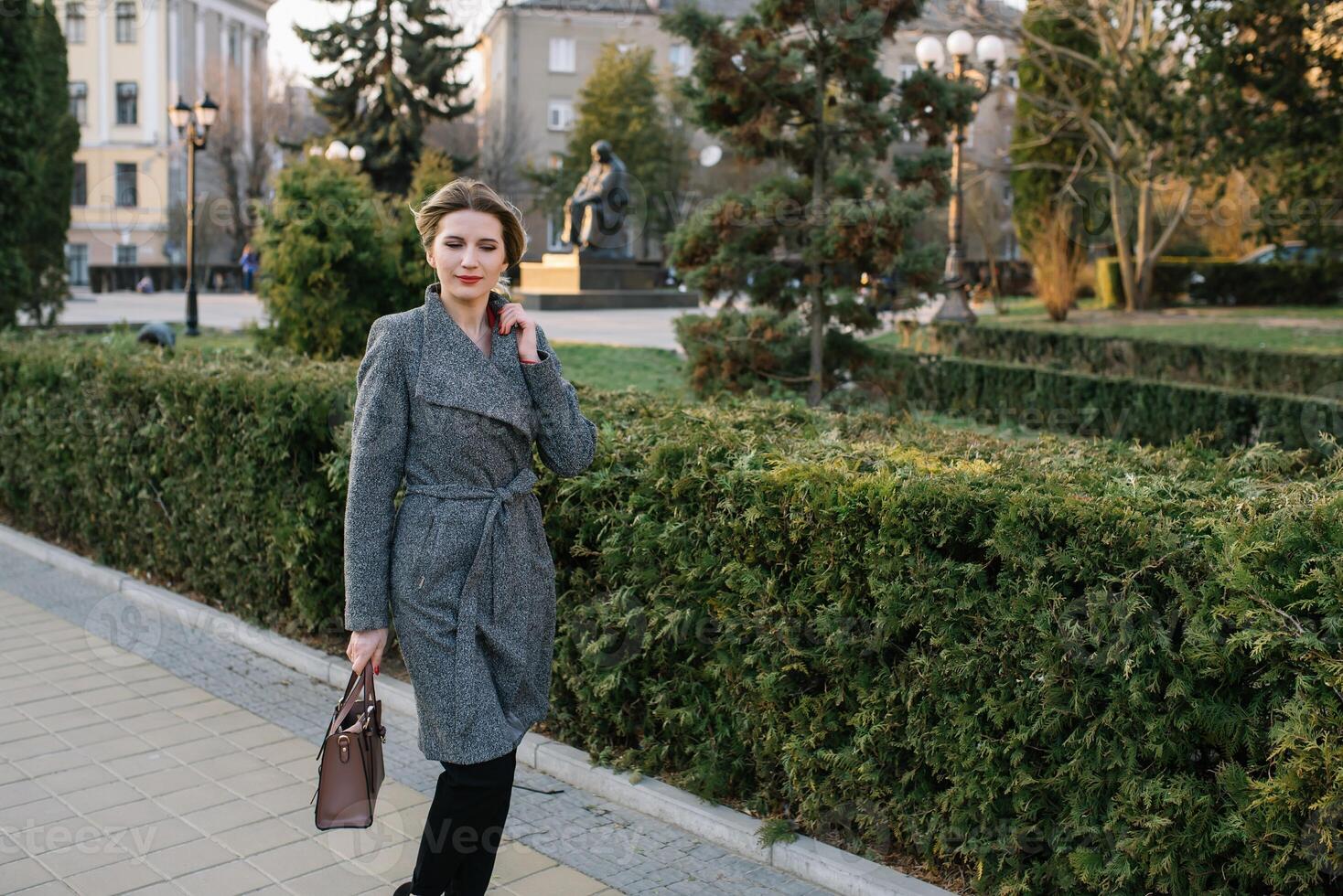 Portrait of business women in feeling of concentrate stress and see stand and hold the paper file sheet in the outdoor pedestrian walk way with the city space of exterior modern facade building photo