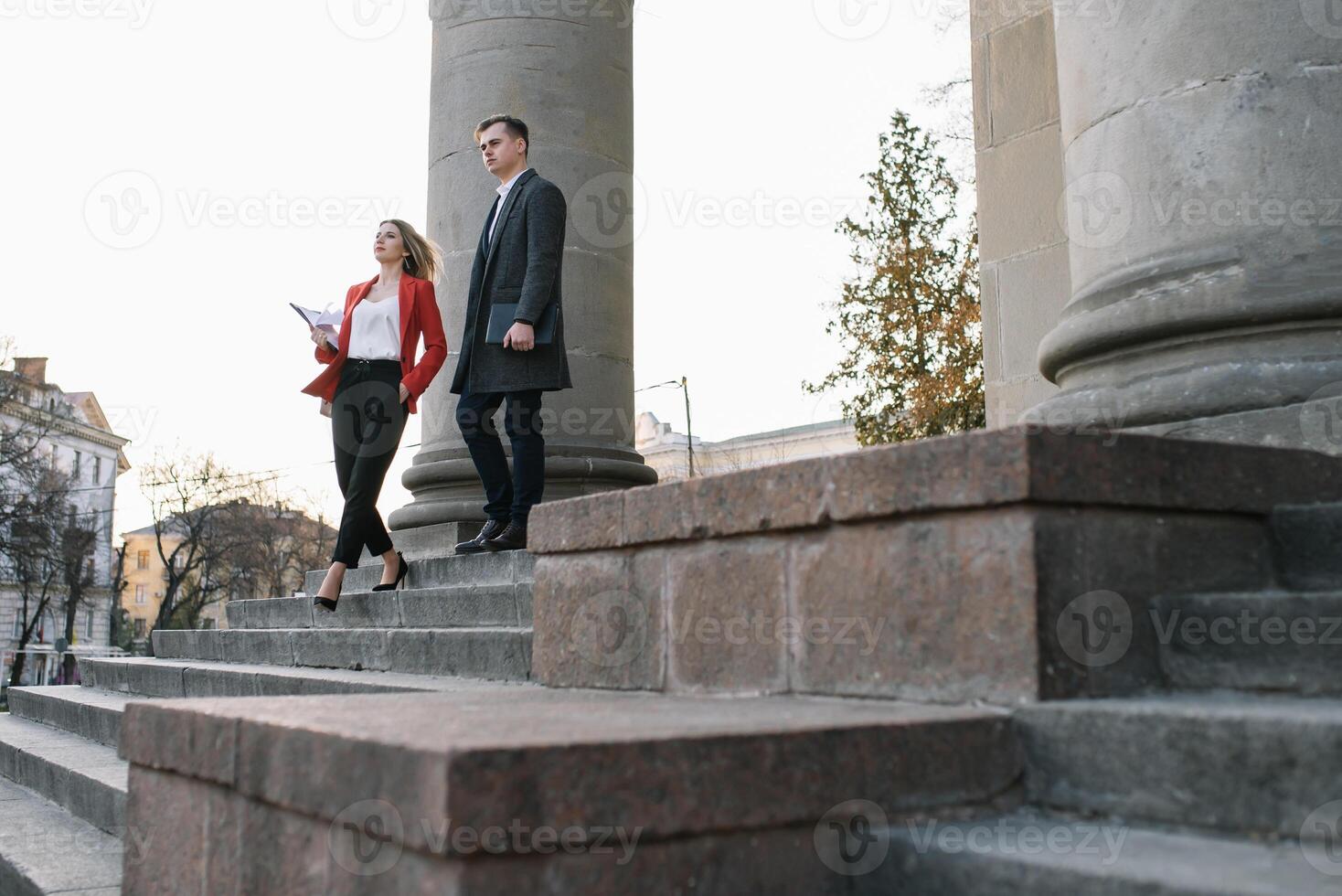 Young business people walking together along the street photo