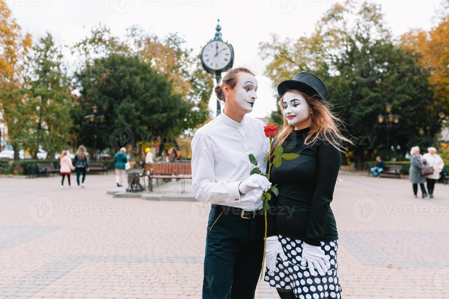 A couple of merry mimes. He hurries on a date. photo