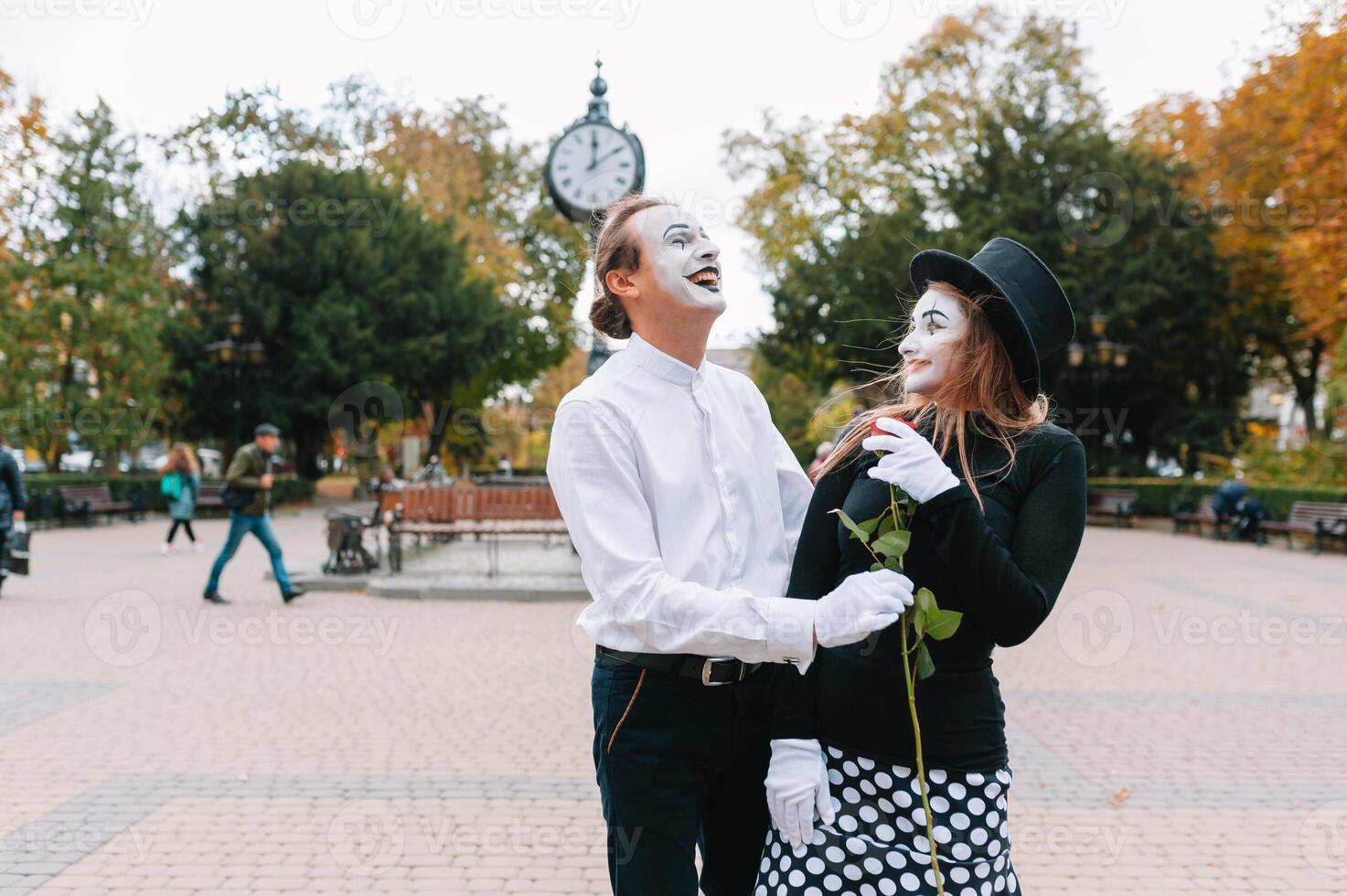 A couple of merry mimes. He hurries on a date. photo