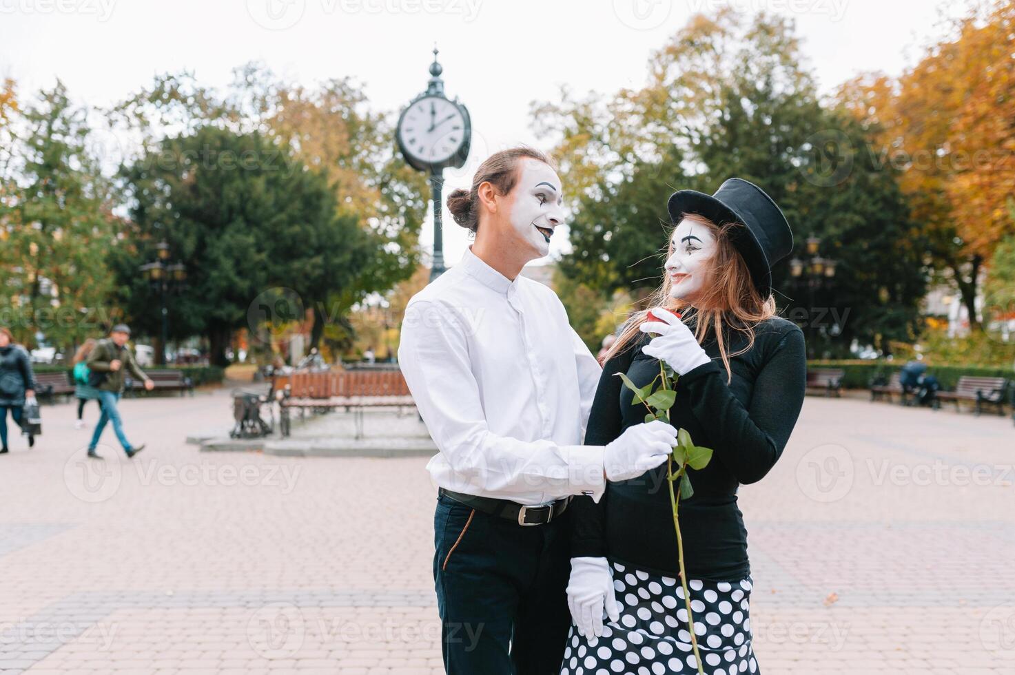 A couple of merry mimes. He hurries on a date. photo