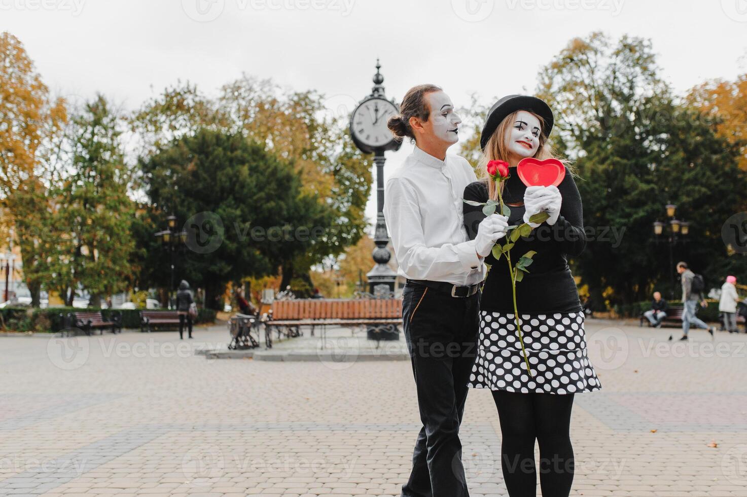 A couple of merry mimes. He hurries on a date. photo