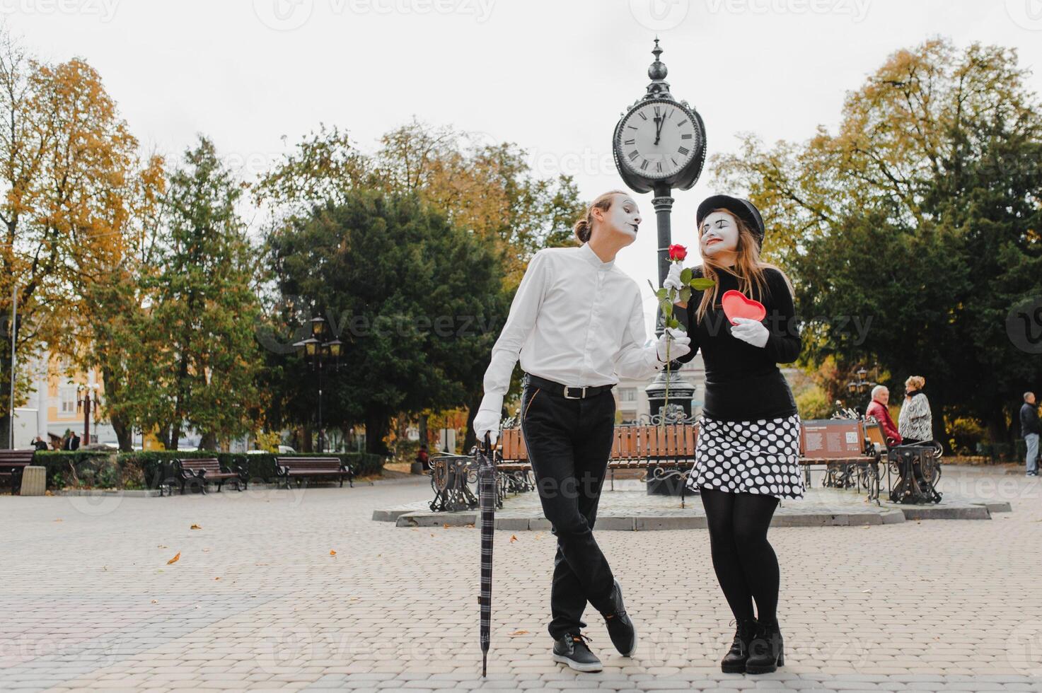 A couple of merry mimes. He hurries on a date. photo