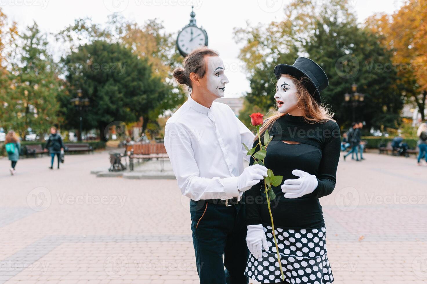 A couple of merry mimes. He hurries on a date. photo