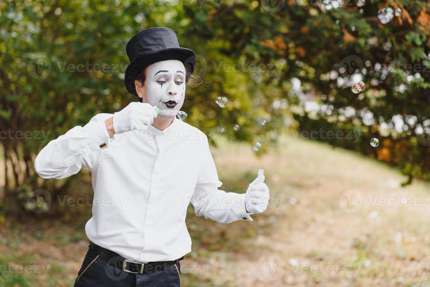 Mime artist blowing a bubble photo