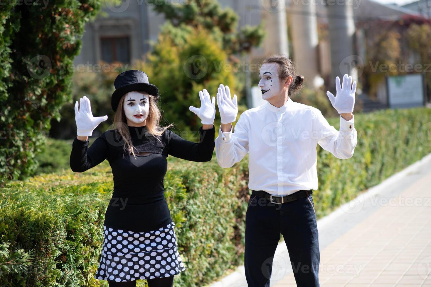 A couple of merry mimes. He hurries on a date. photo