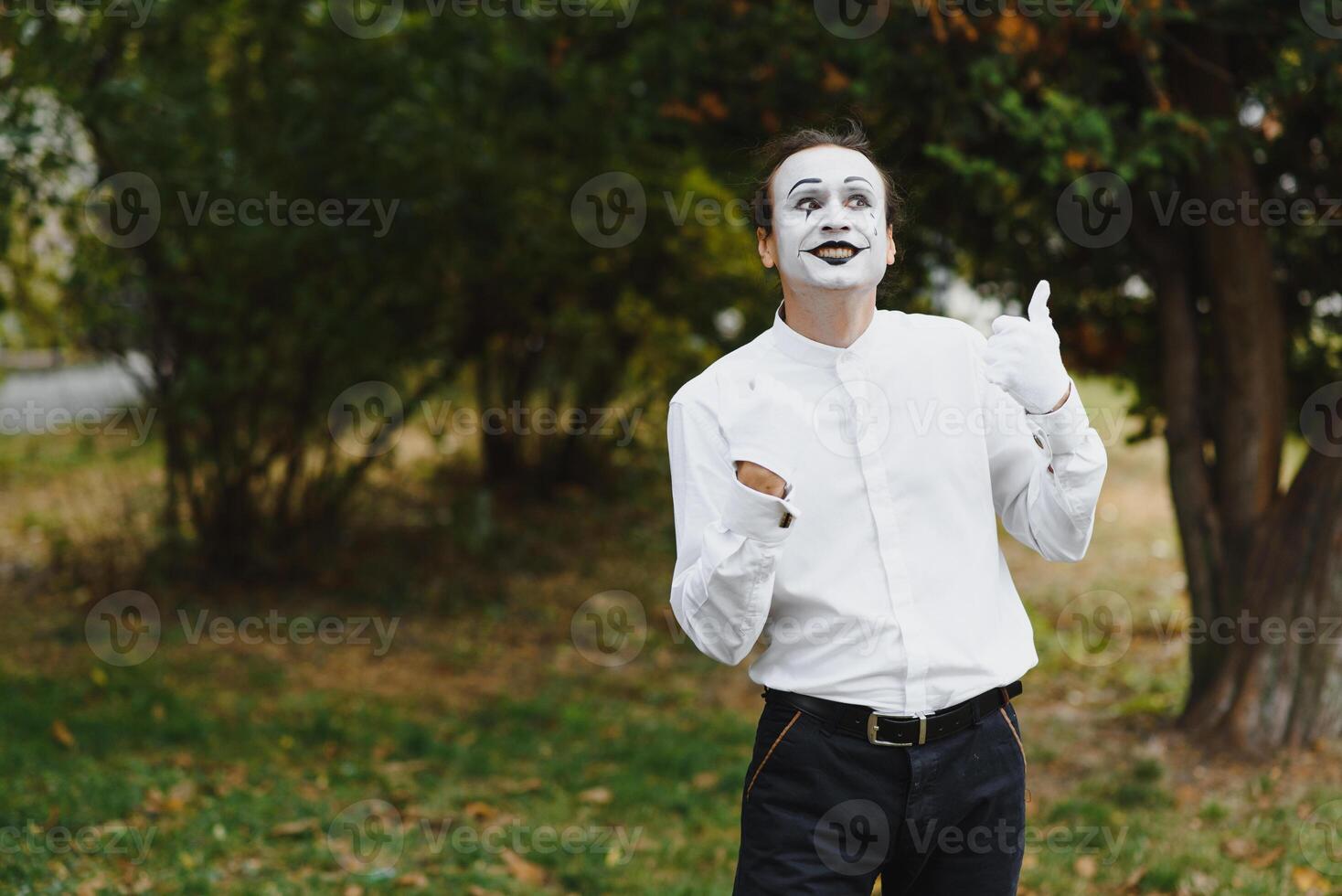 Portrait of a man, artist,clown, MIME. Shows something. Mime actor shows different emotions. photo