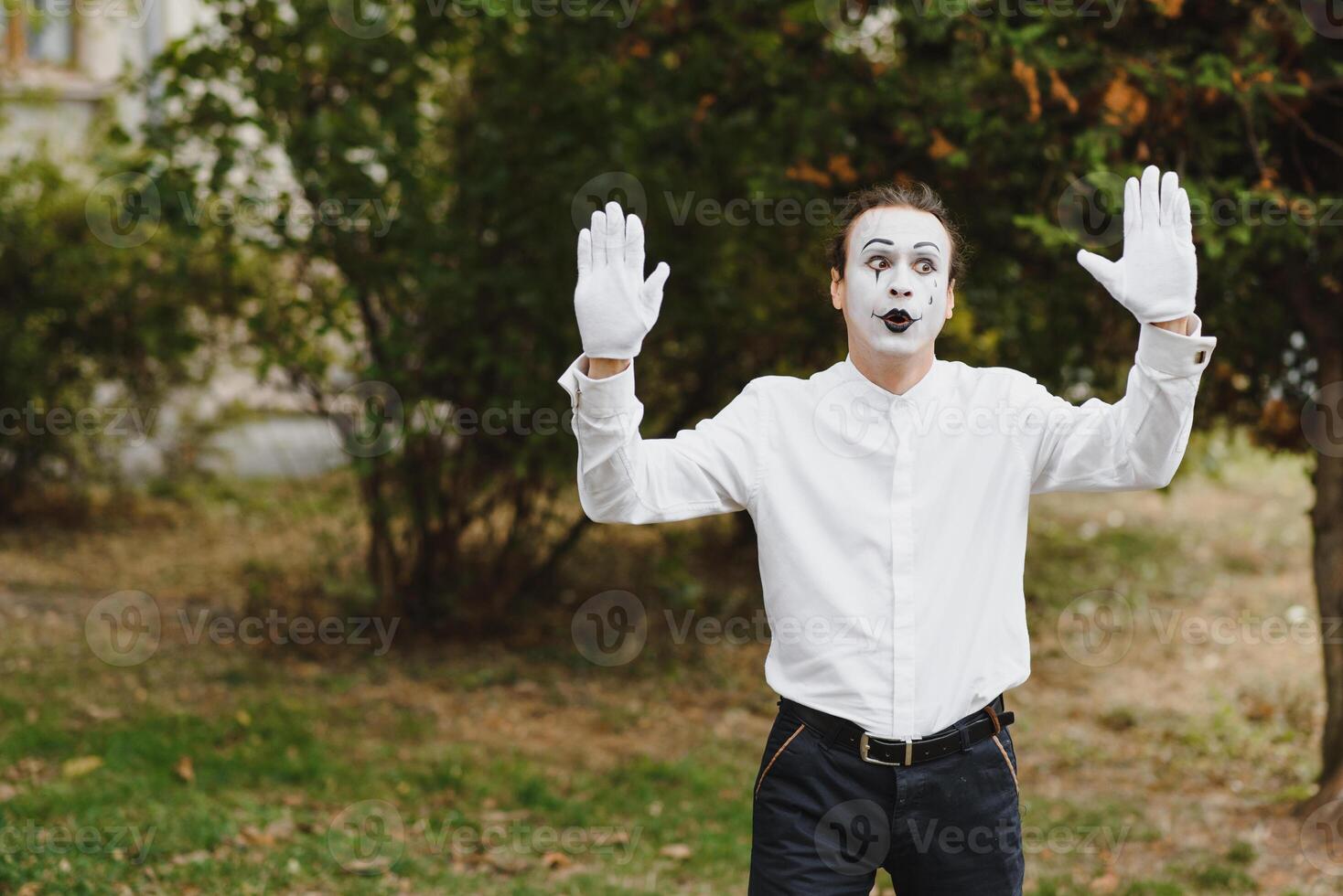 Portrait of a man, artist,clown, MIME. Shows something. Mime actor shows different emotions. photo