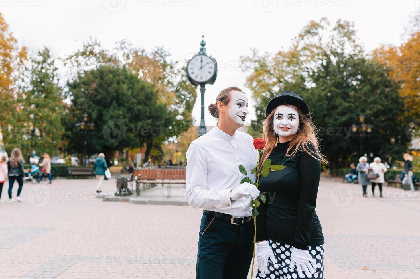 A couple of merry mimes. He hurries on a date. photo