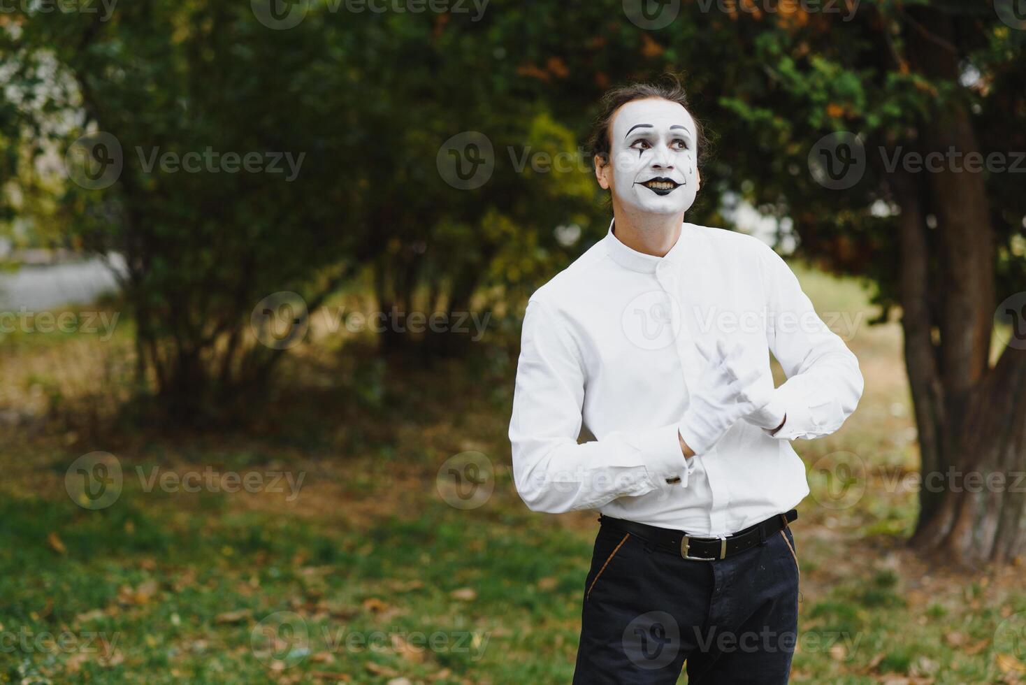 Portrait of a man, artist,clown, MIME. Shows something. Mime actor shows different emotions. photo
