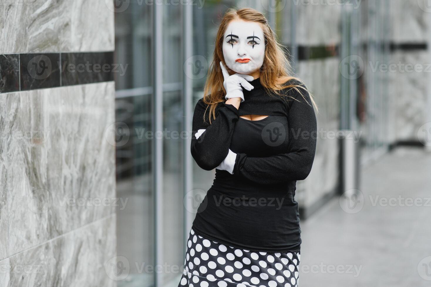 The girl with makeup of the mime. improvisation. mime shows different emotions photo