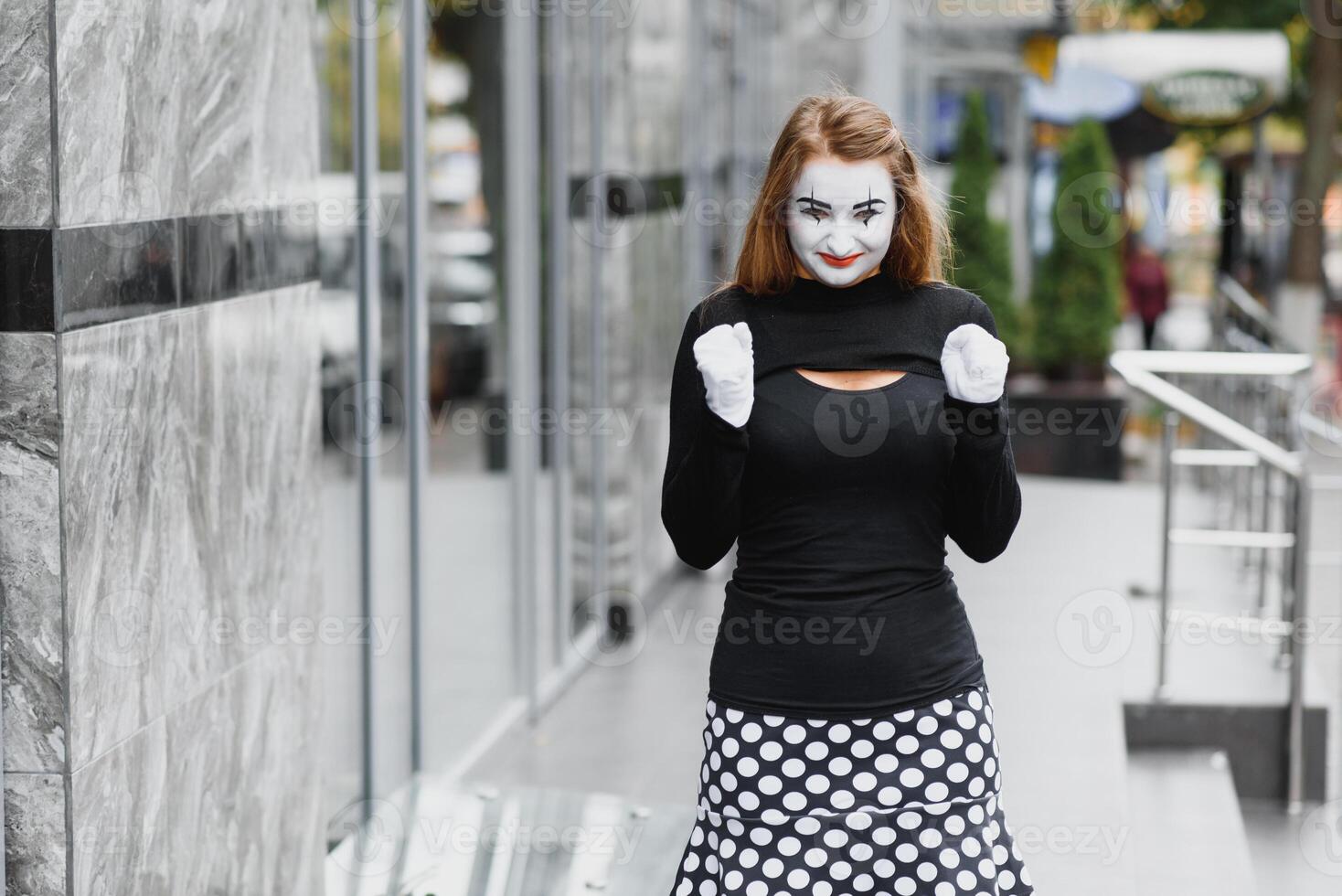 The girl with makeup of the mime. improvisation. mime shows different emotions photo