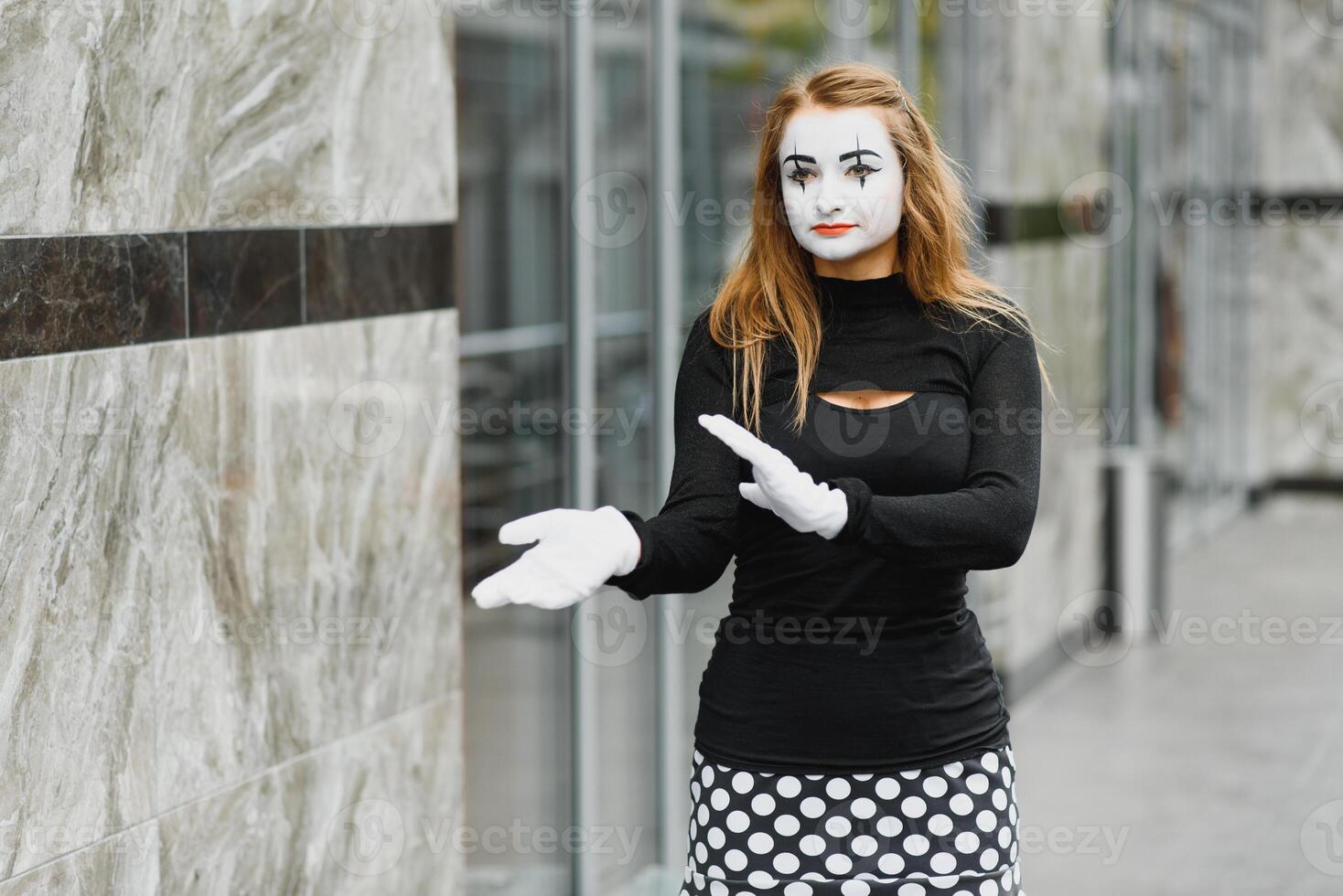 Portrait of a mime comedian. mime girl on the street photo