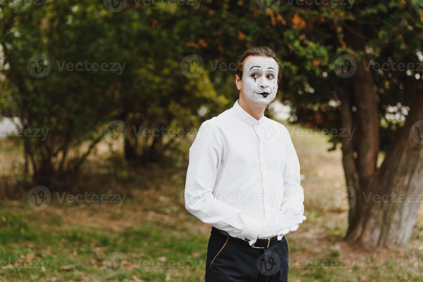 Portrait of a man, artist,clown, MIME. Shows something. Mime actor shows different emotions. photo