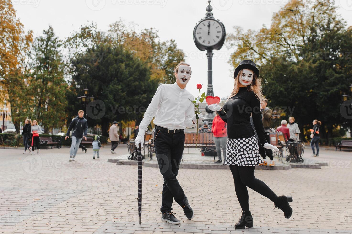 A couple of merry mimes. He hurries on a date. photo