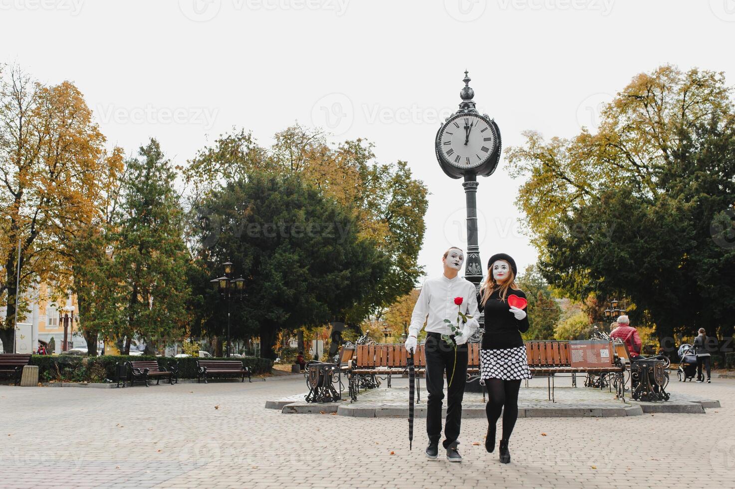 A couple of merry mimes. He hurries on a date. photo