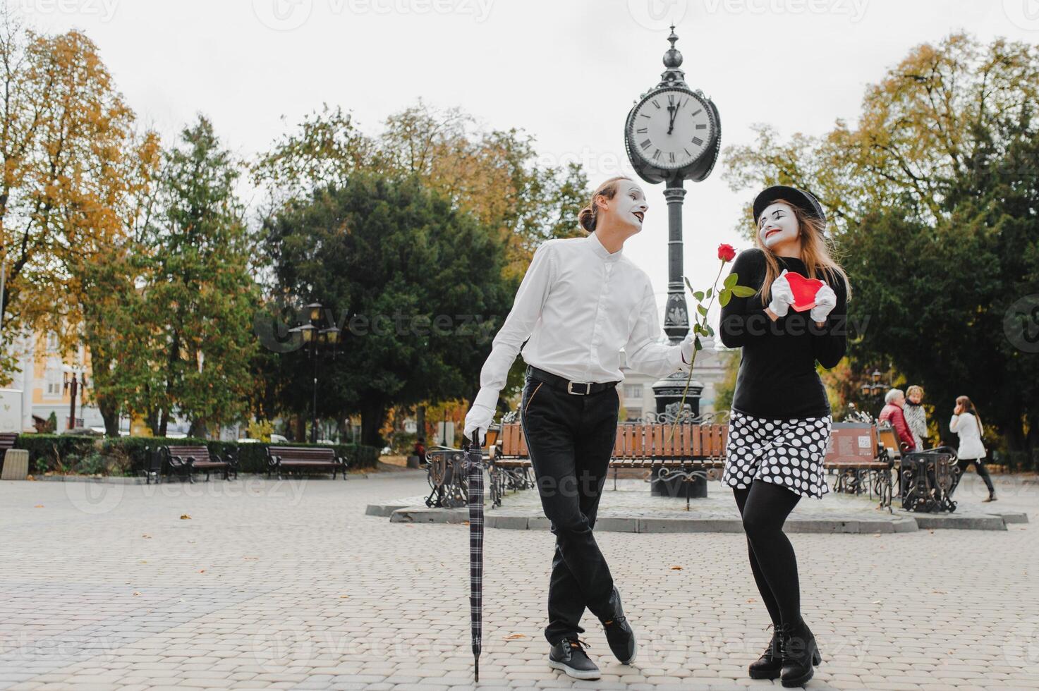 A couple of merry mimes. He hurries on a date. photo