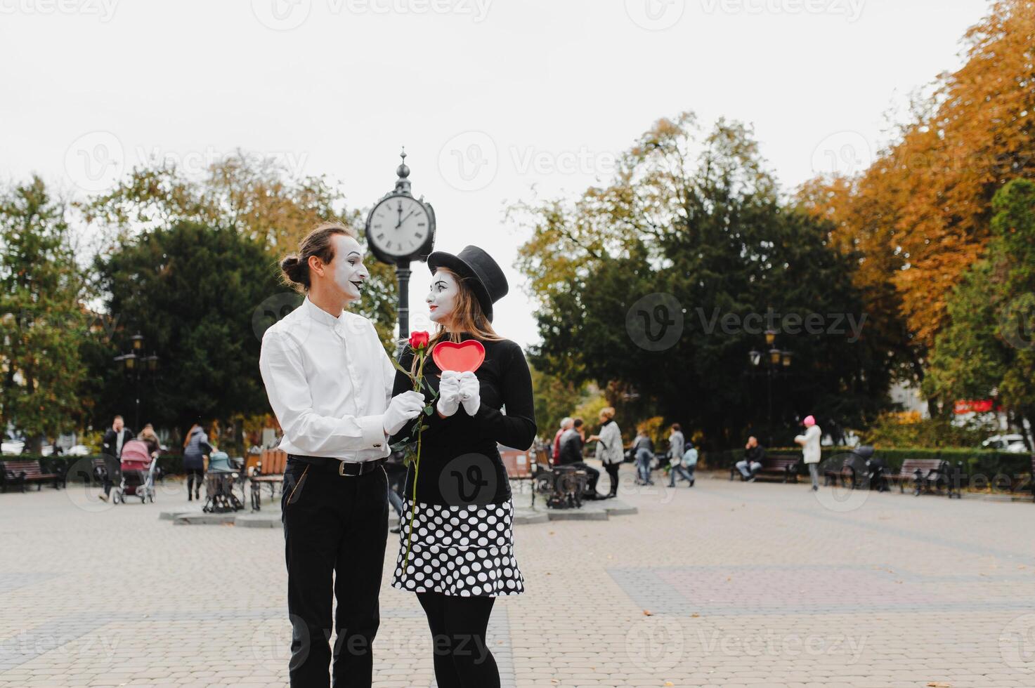 A couple of merry mimes. He hurries on a date. photo
