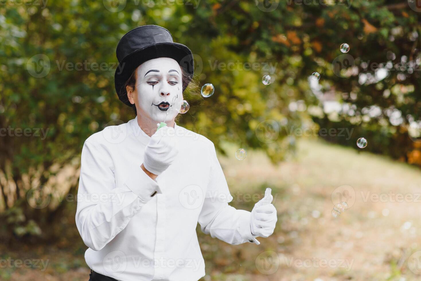 Mime artist blowing a bubble photo