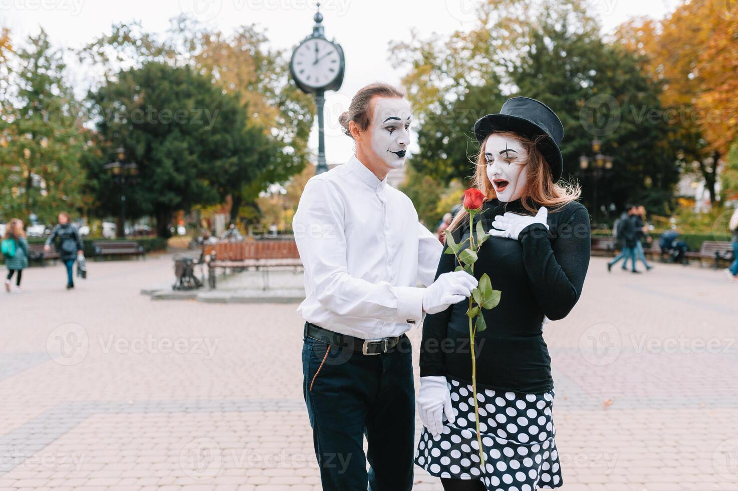 A couple of merry mimes. He hurries on a date. photo