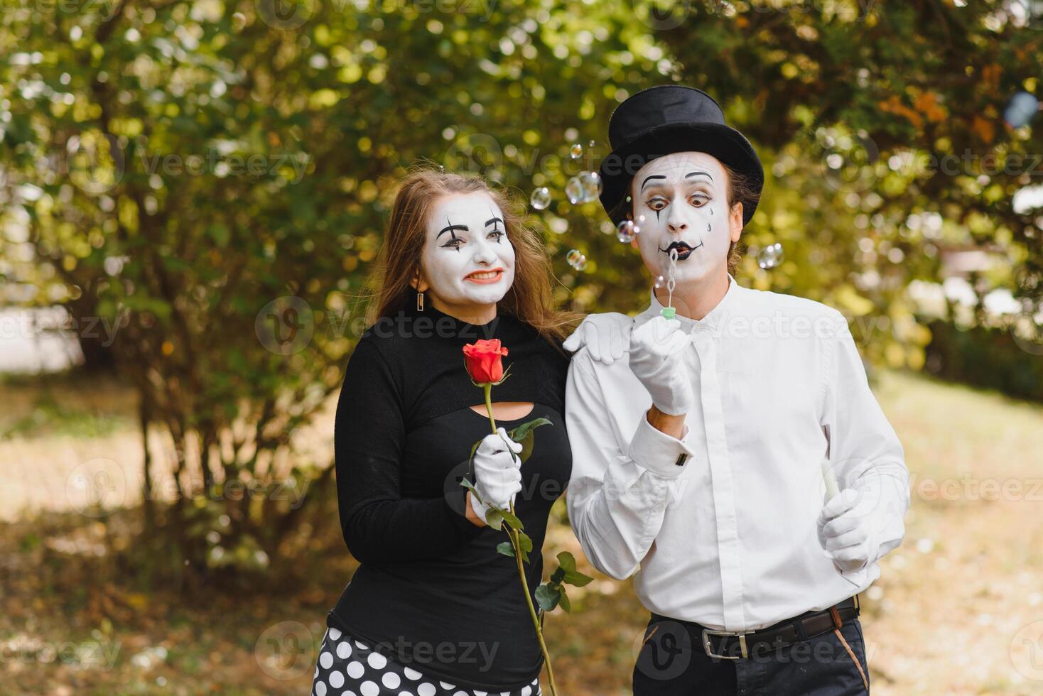 A couple of merry mimes. He hurries on a date. photo