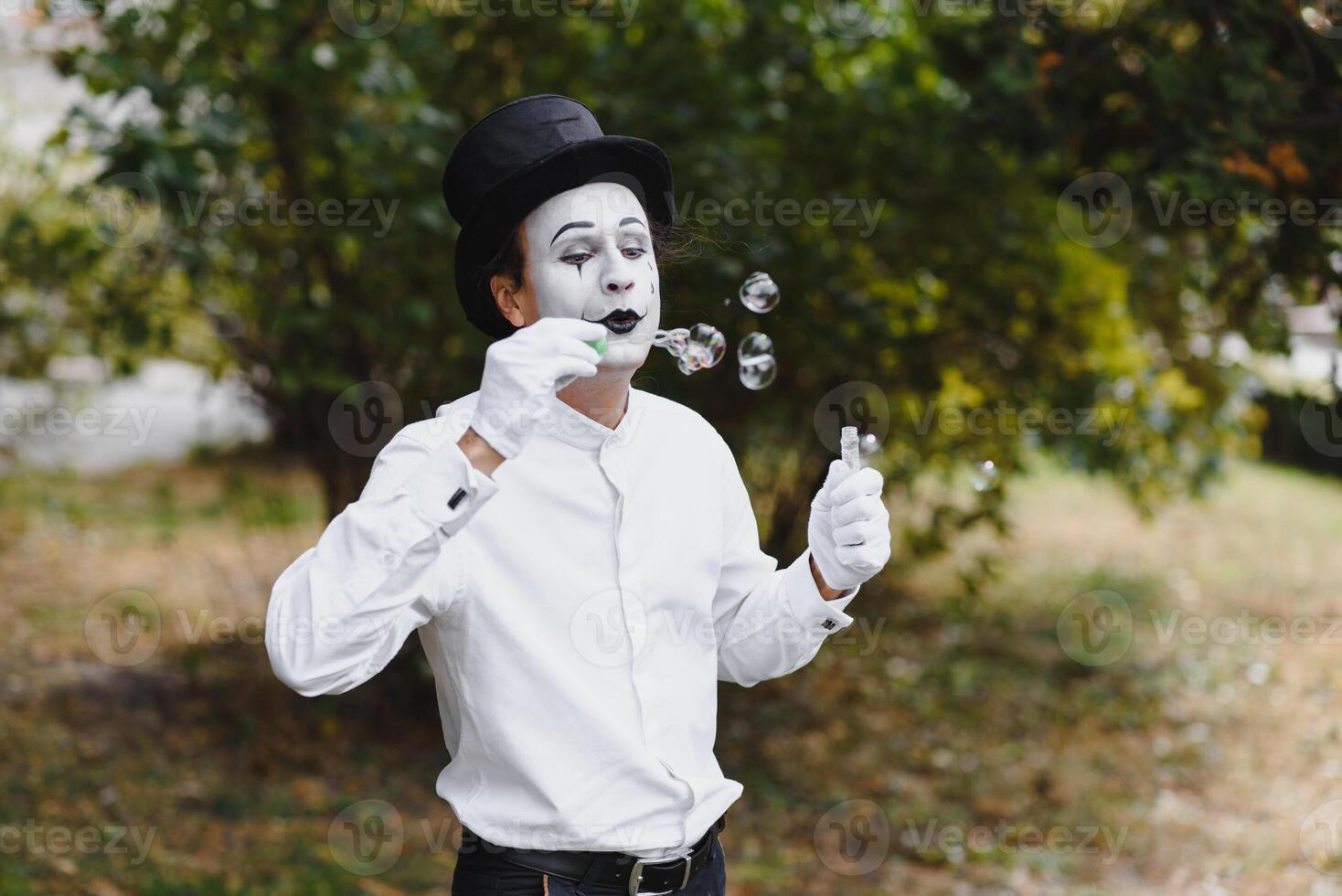 Mime artist blowing a bubble photo
