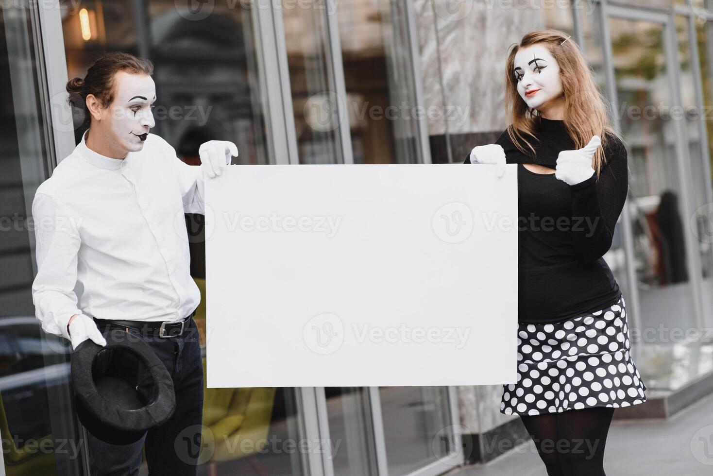 couple funny mimes holding sign photo