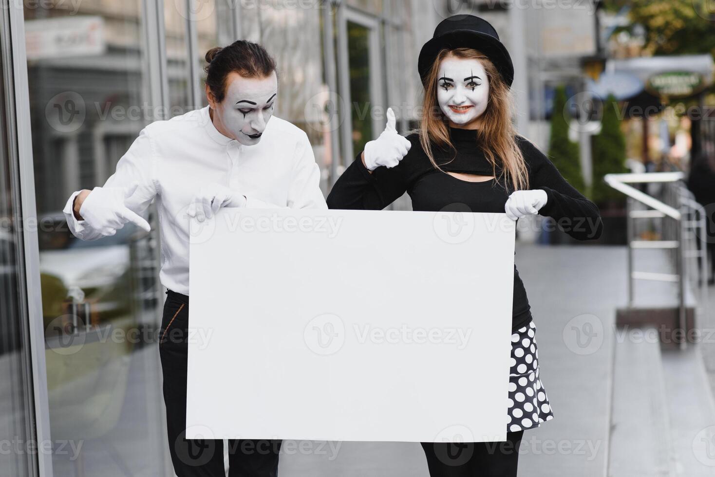 couple funny mimes holding sign photo