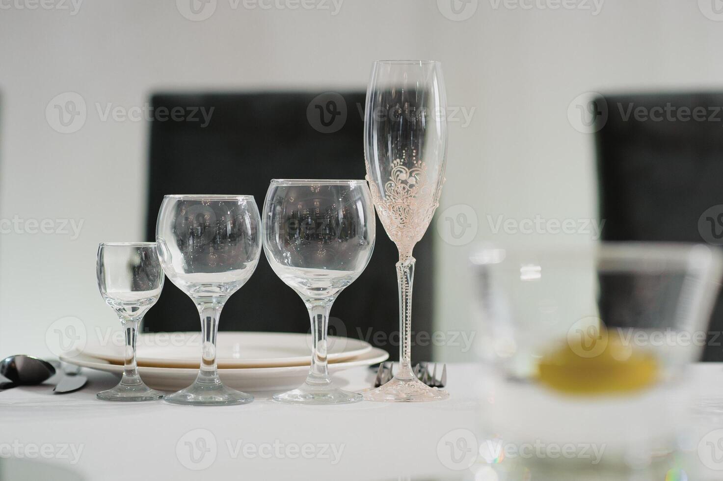 Glasses on the festive table setting. Wedding table decor concept. Table setting in classic style, setout. fine art. photo