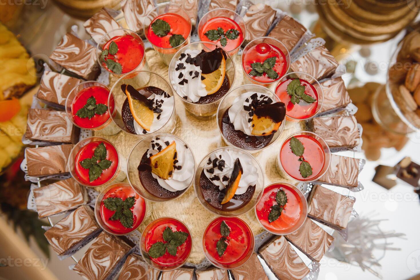 desserts with fruits, mousse, biscuits. Different types of sweet pastries, small colorful sweet cakes, macaron, and other desserts in the sweet buffet. candy bar for birthday photo