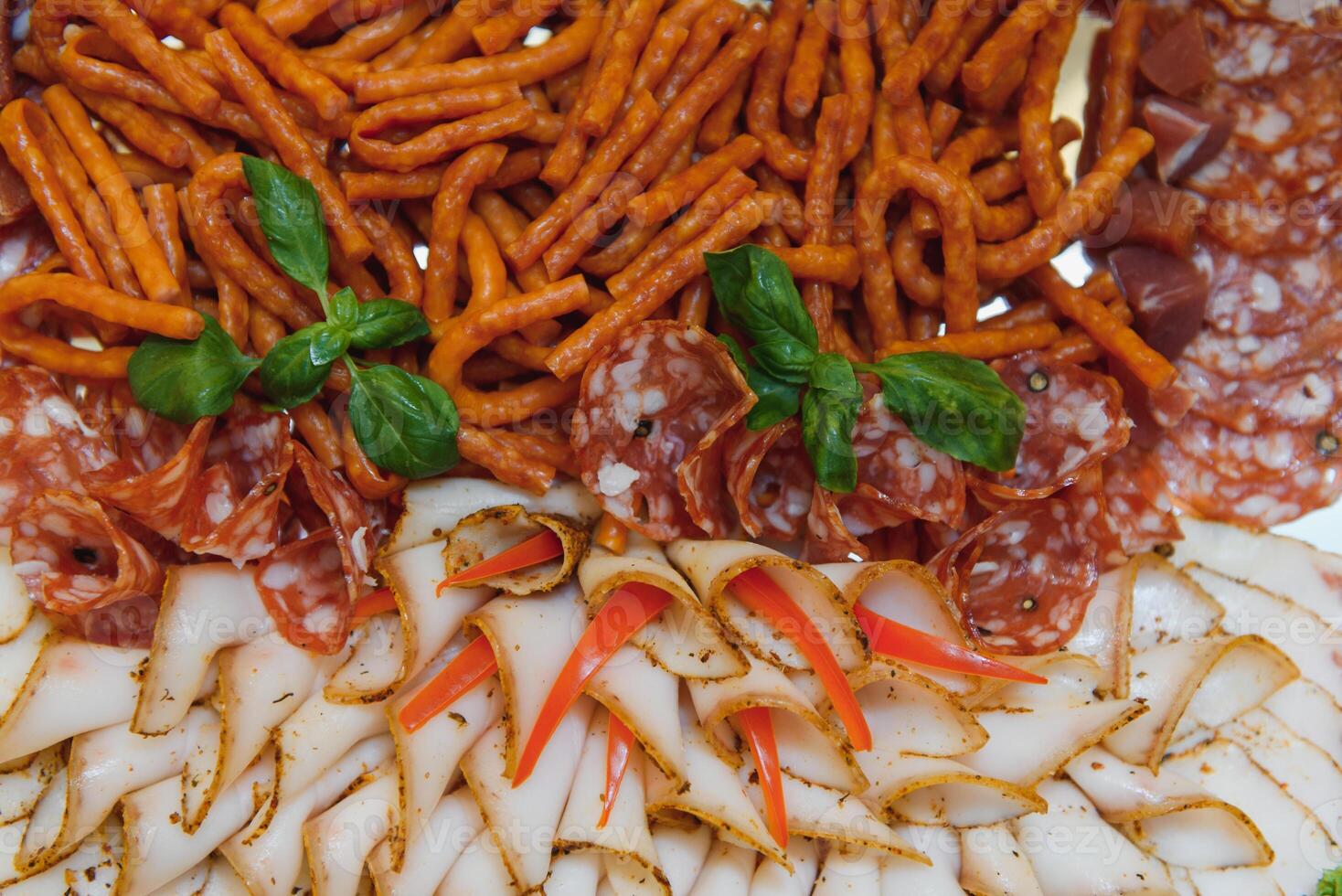 Meat and cheese appetizers. Antipasti and catering platter with different meat and cheese products. photo
