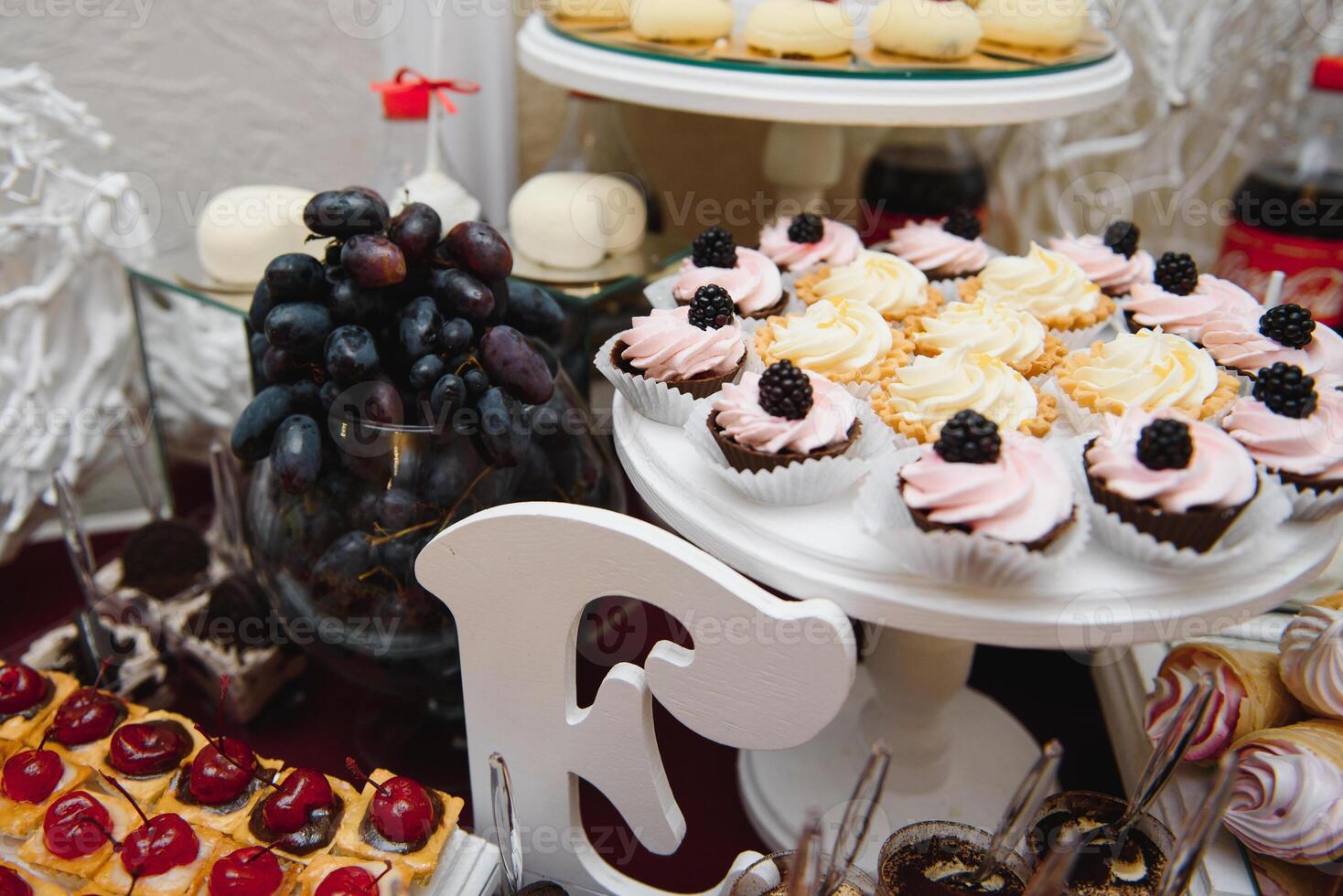 desserts with fruits, mousse, biscuits. Different types of sweet pastries, small colorful sweet cakes, macaron, and other desserts in the sweet buffet. candy bar for birthday photo