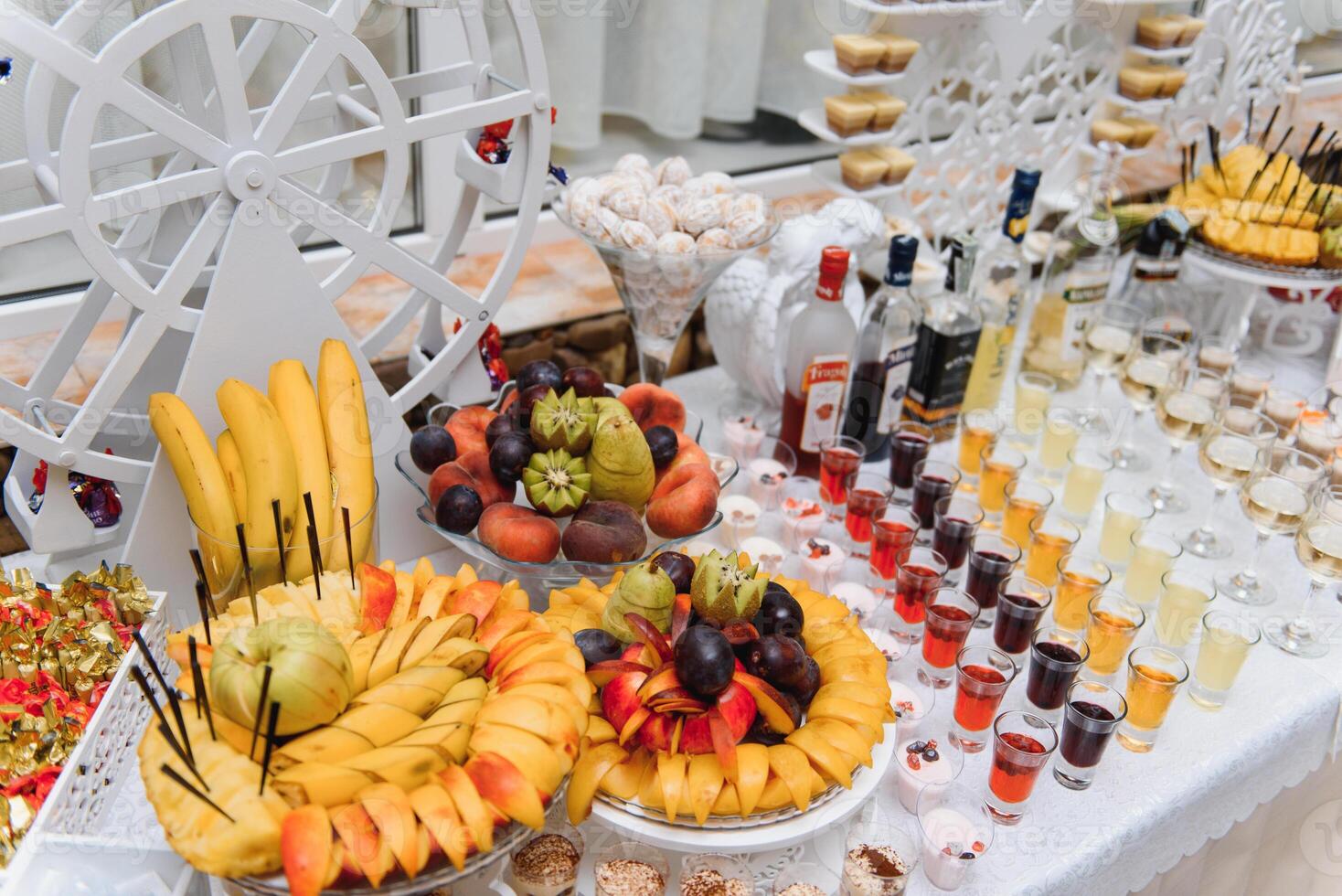 Delicious sweets on wedding candy buffet with desserts, cupcakes,tiramisu and cookies photo