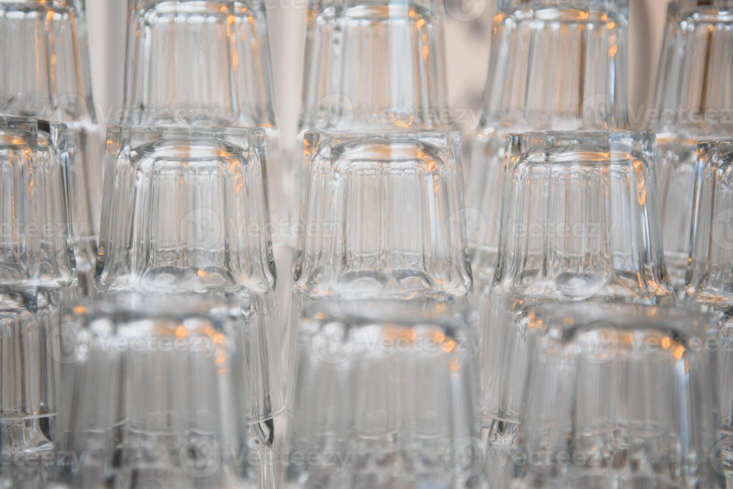 Crystal clear empty wine glasses on the table. Alcohol background. A lot of wine glasses at the bar.background with glass glasses photo