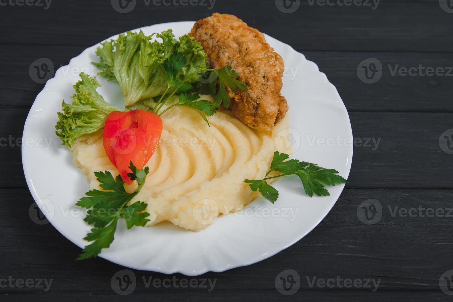 mashed potatoes with meat and vegetables on wooden background photo