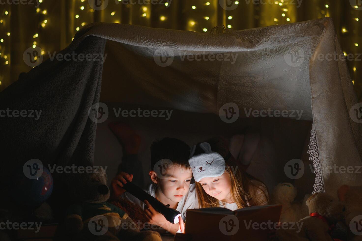 Little children reading bedtime story at home photo