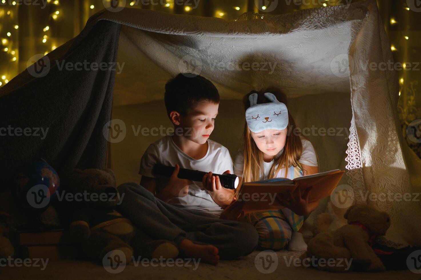 Little children reading bedtime story at home photo