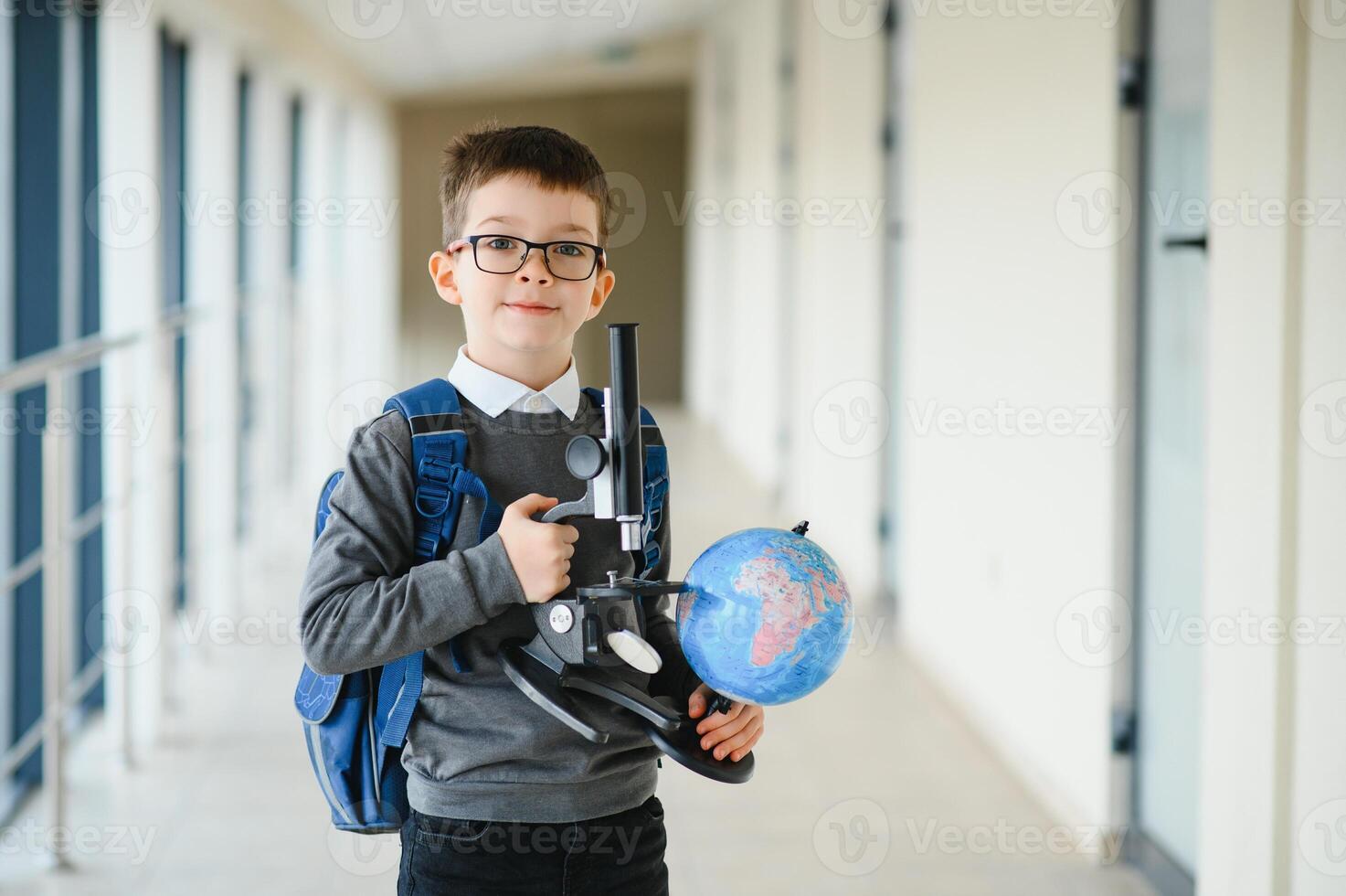 Cheerful smiling little boy with big backpack having fun. School concept. Back to School. photo