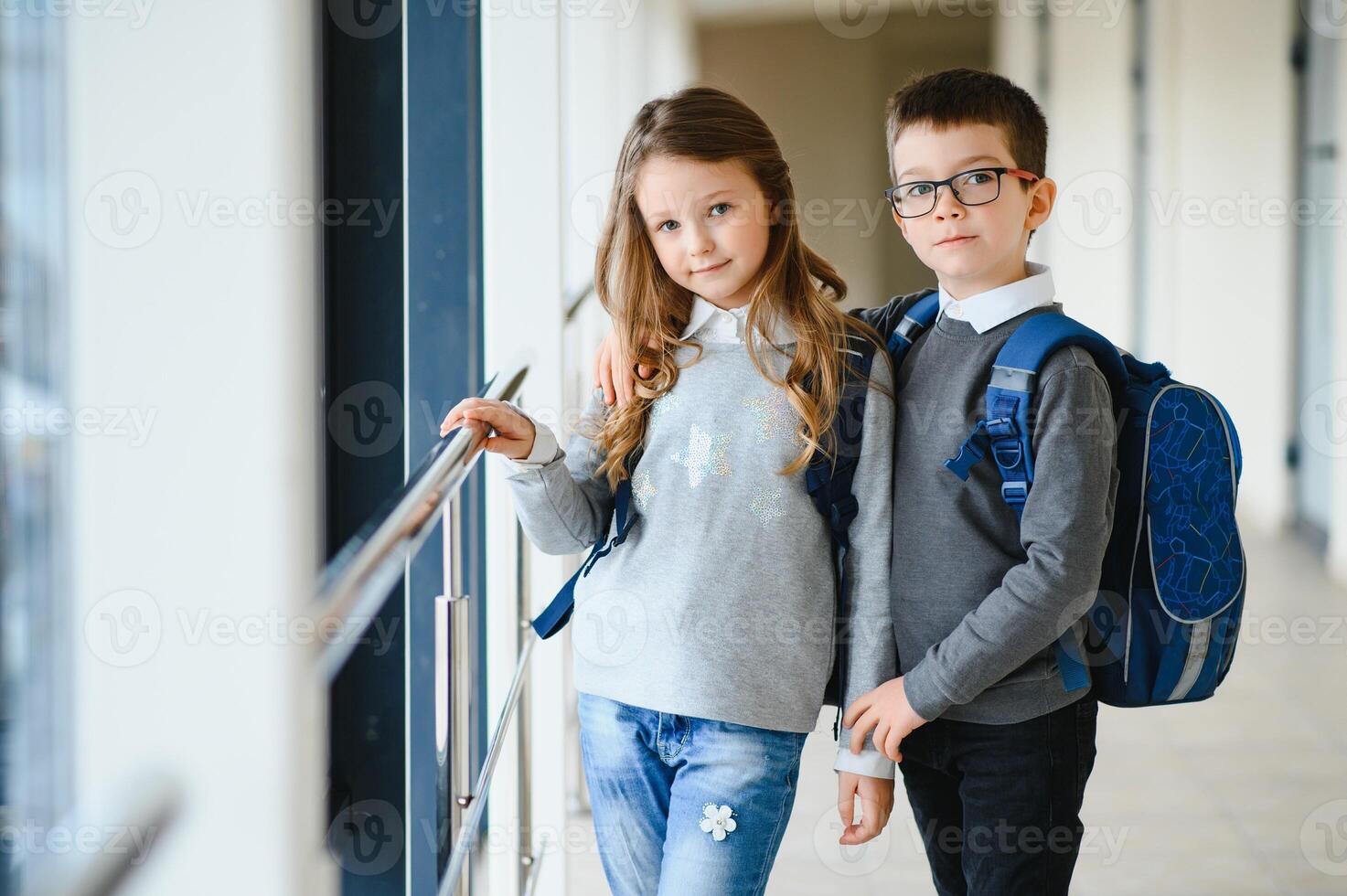 School kids in uniform together in corridor. Conception of education. photo